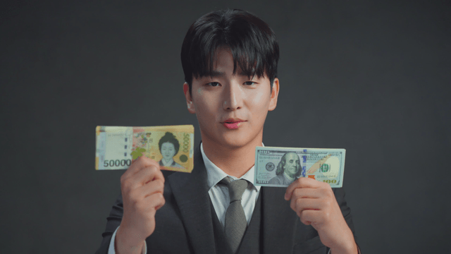 Man comparing Korean and US currency