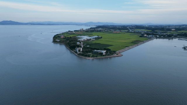 Peninsula with green fields and coastline