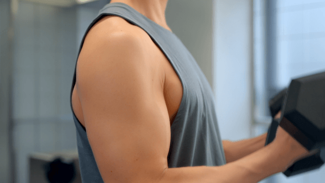 Man lifting dumbbells in a gym