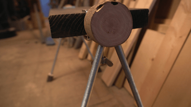 Wooden bench with metal legs in workshop