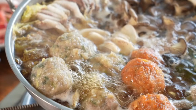A pot of Korean hot pot with dumplings