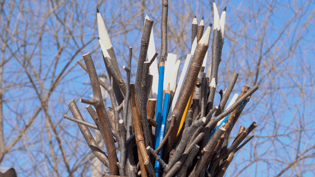 Wooden pencil sculpture placed on a roof