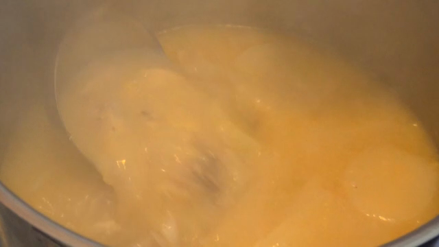 A pot of soup being stirred