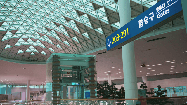 Modern airport terminal with gate signs