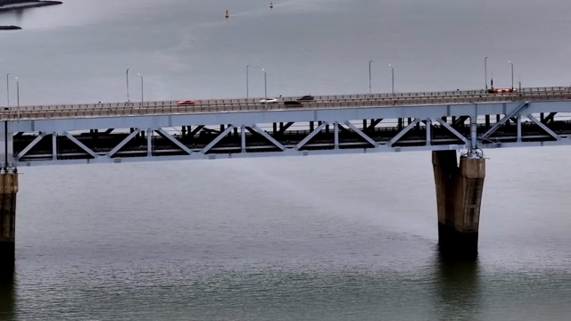 A large bridge spanning over calm water