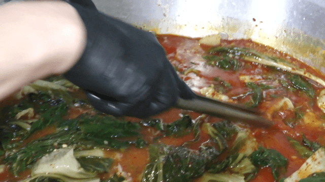 Red broth infused with outer leaves
