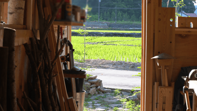 Wood workshop overlooking a green field