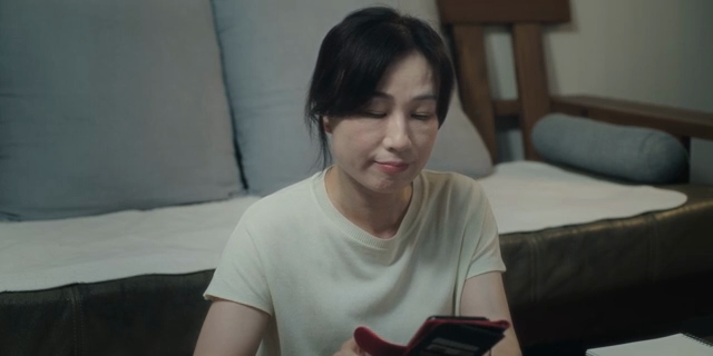 Woman sighing while looking at her smartphone