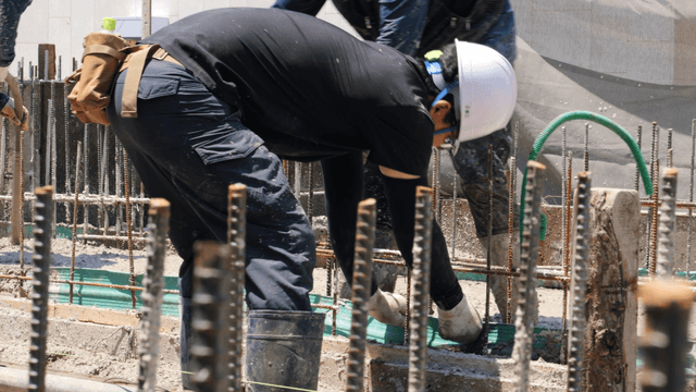 Construction worker organizing cables