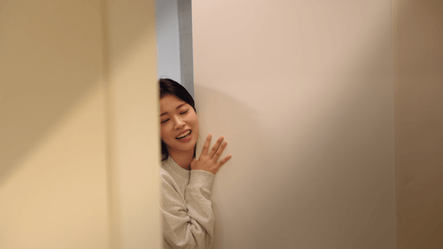 Young woman smiling toward entrance