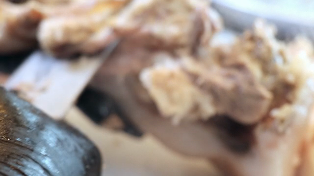 Close-up of meat being cut with a knife