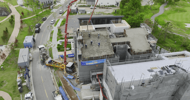 Construction workers pouring concrete