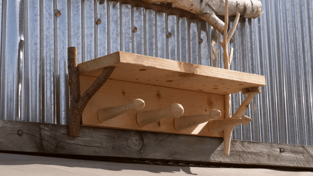 Wooden wall shelf mounted on a metal surface