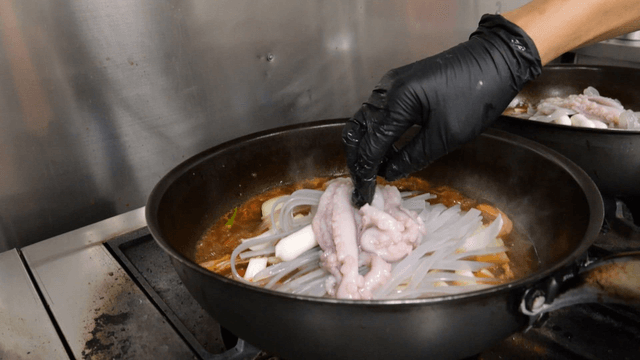 Octopus added to boiling soy-braised chicken