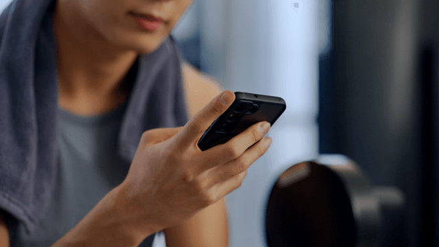 Man using a smartphone in a gym