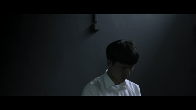 Young man in a dimly lit room