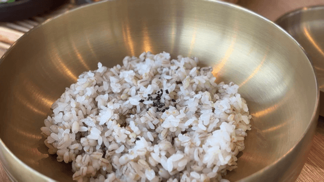Bowl of barley rice on table