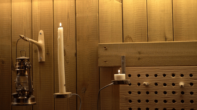 Lighting a candle in a wooden room
