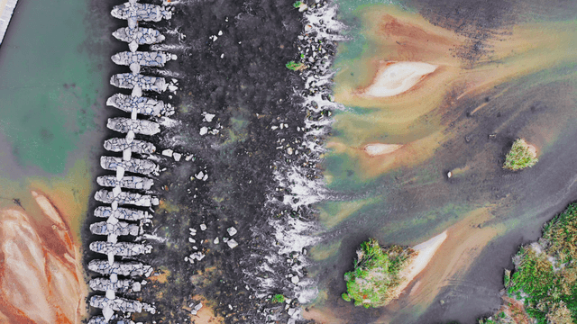 River with stone bridge and sand