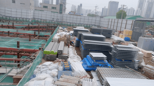 Construction site with materials and cranes