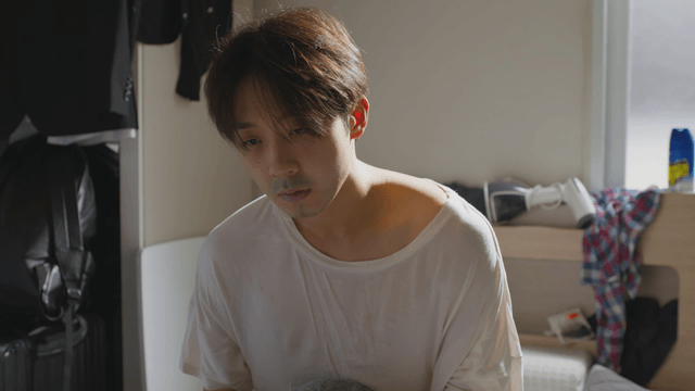 Man waking up in a sunlit room