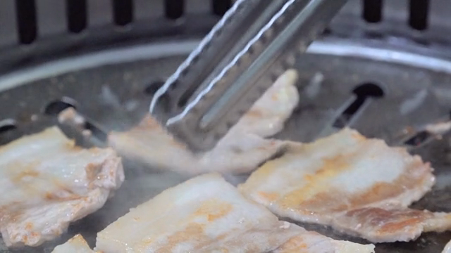 Grilling pork belly on a hot grill