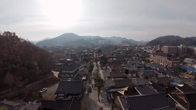 Traditional Hanok village with mountains