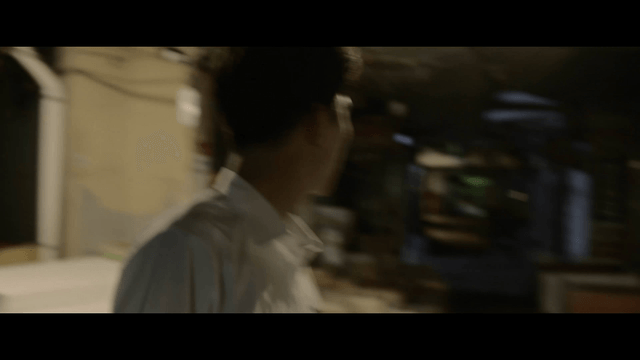 Student running through dark alley searching for something