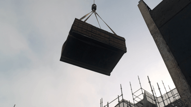 Crane lowering materials at construction site