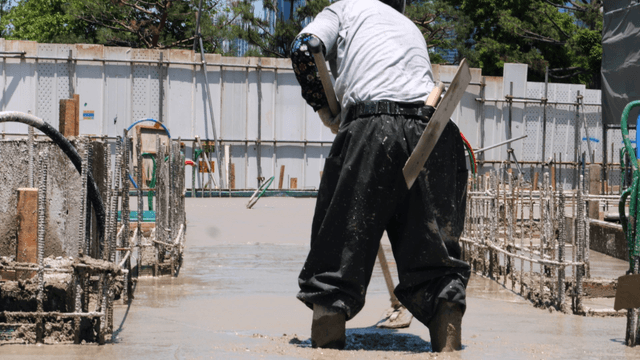 Construction worker smoothing concrete
