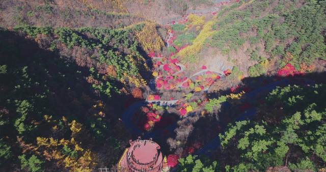 Colorful autumn hills and winding road viewpoint