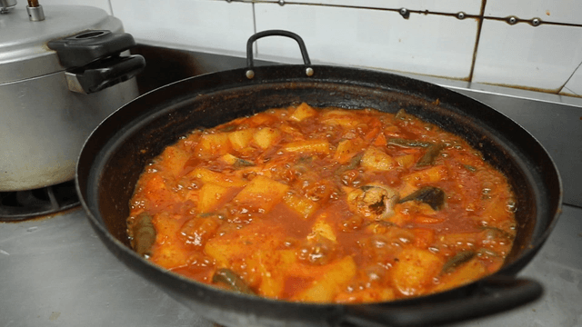 Mackerel and radish stew boiling on the stove