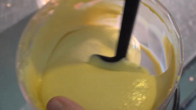 Mixing sauce in a bowl with a spatula