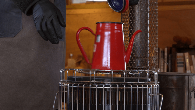 Red kettle on stove in a cozy room