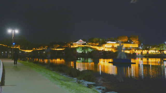 Night view of Korean fortress and pavilion with flowing river