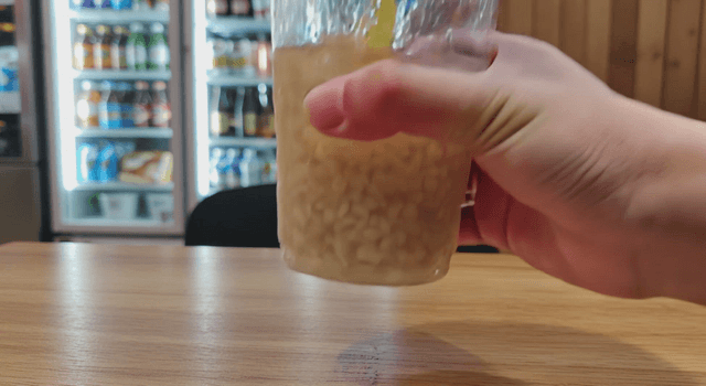 A cup of sikhye on a wooden table