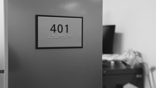Room 401 door with braille sign