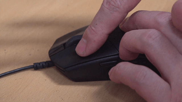 Hand inspecting computer mouse buttons