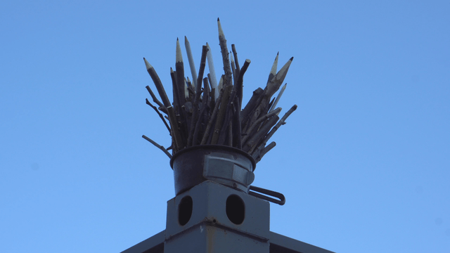 Wooden pencil sculpture under the clear sky