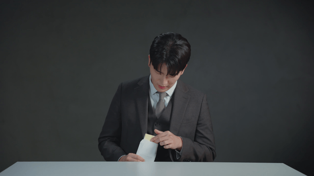 Man secretly counting money inside an envelope