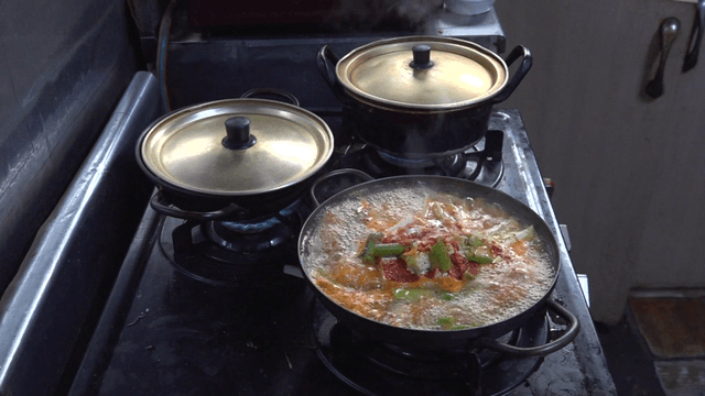 Pots boiling on a gas stove