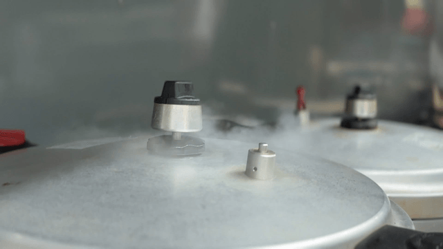 Pressure cooker releasing steam