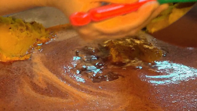 Mixing kabocha squash in a large pot