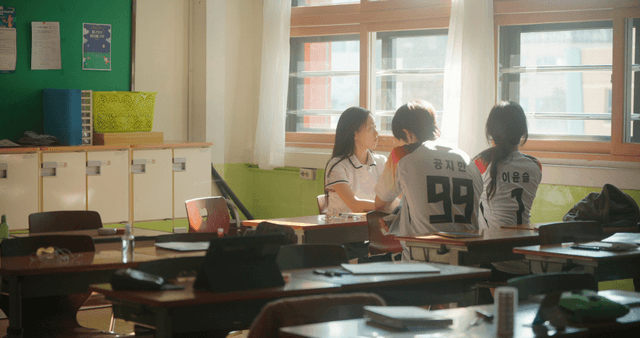 Students talking in a sunlit classroom