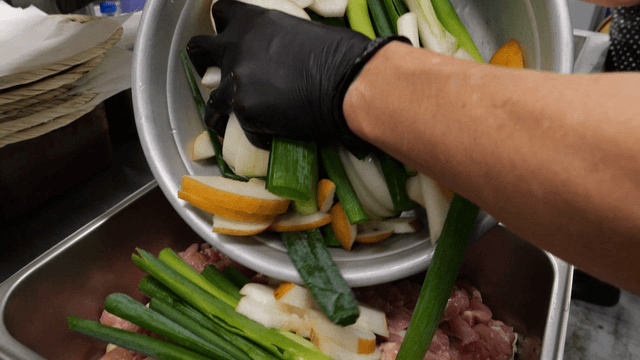 Vegetables placed on raw chicken