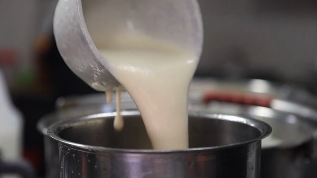 Soybean soup being poured into a pot