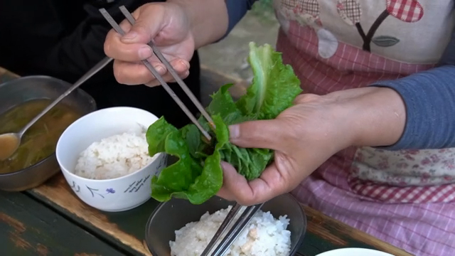 Preparing Korean ssam with rice and side dishes