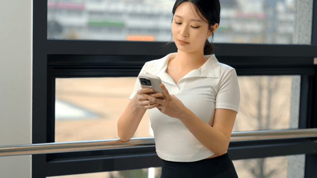 Young woman using a smartphone indoors