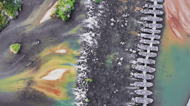 Stone bridge over a mystic-colored river