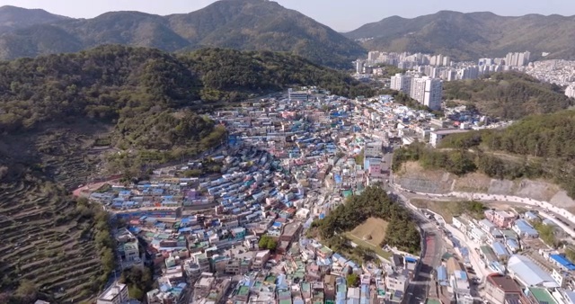 A colorful hillside village with mountains